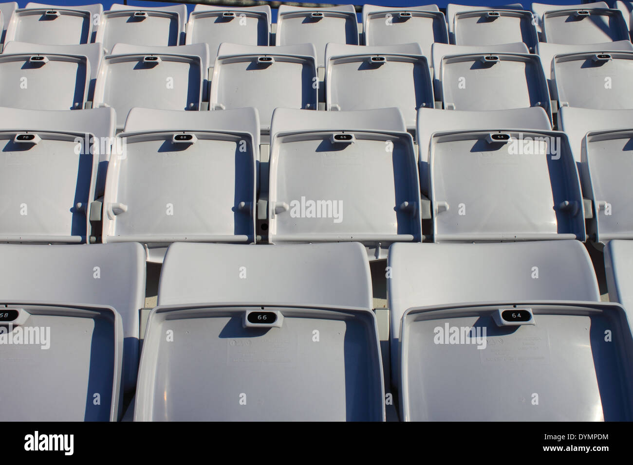 Empty and numbered seats in a stadium Stock Photo