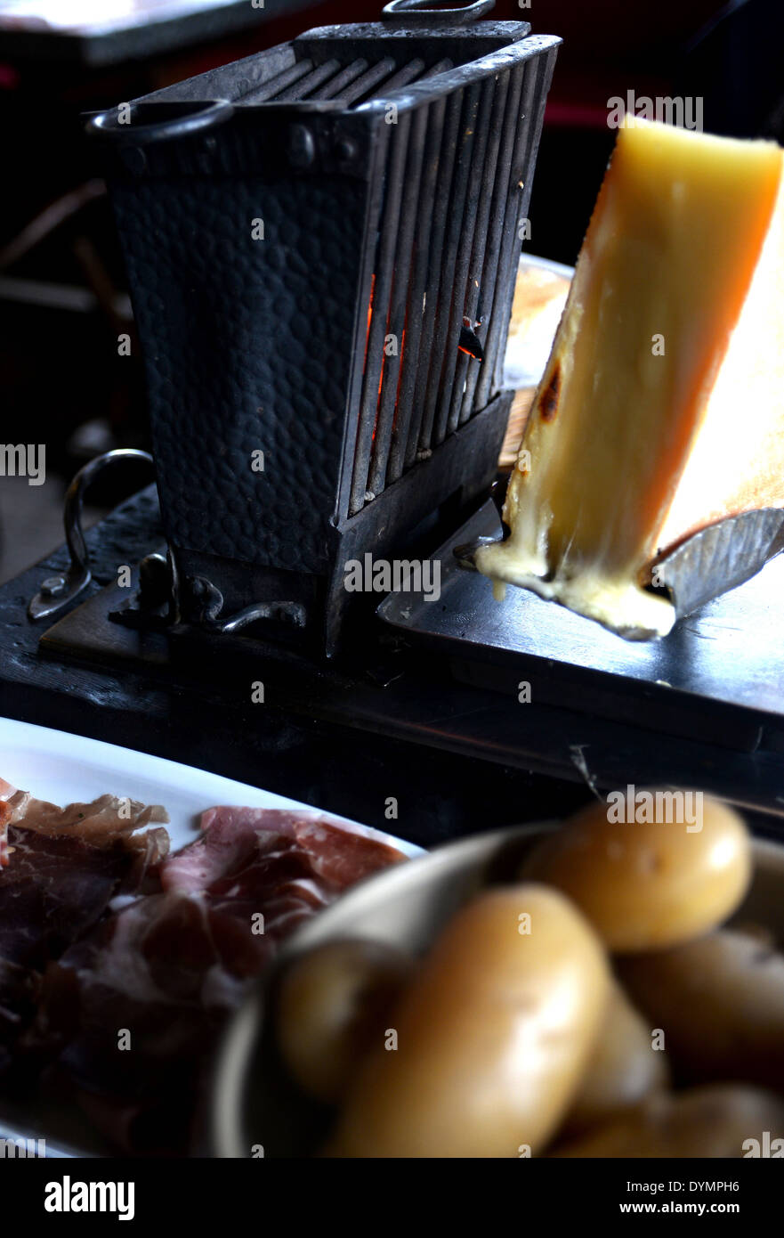 Typical Raclette Typical French food that consists in melting cheese for dipping bread ...