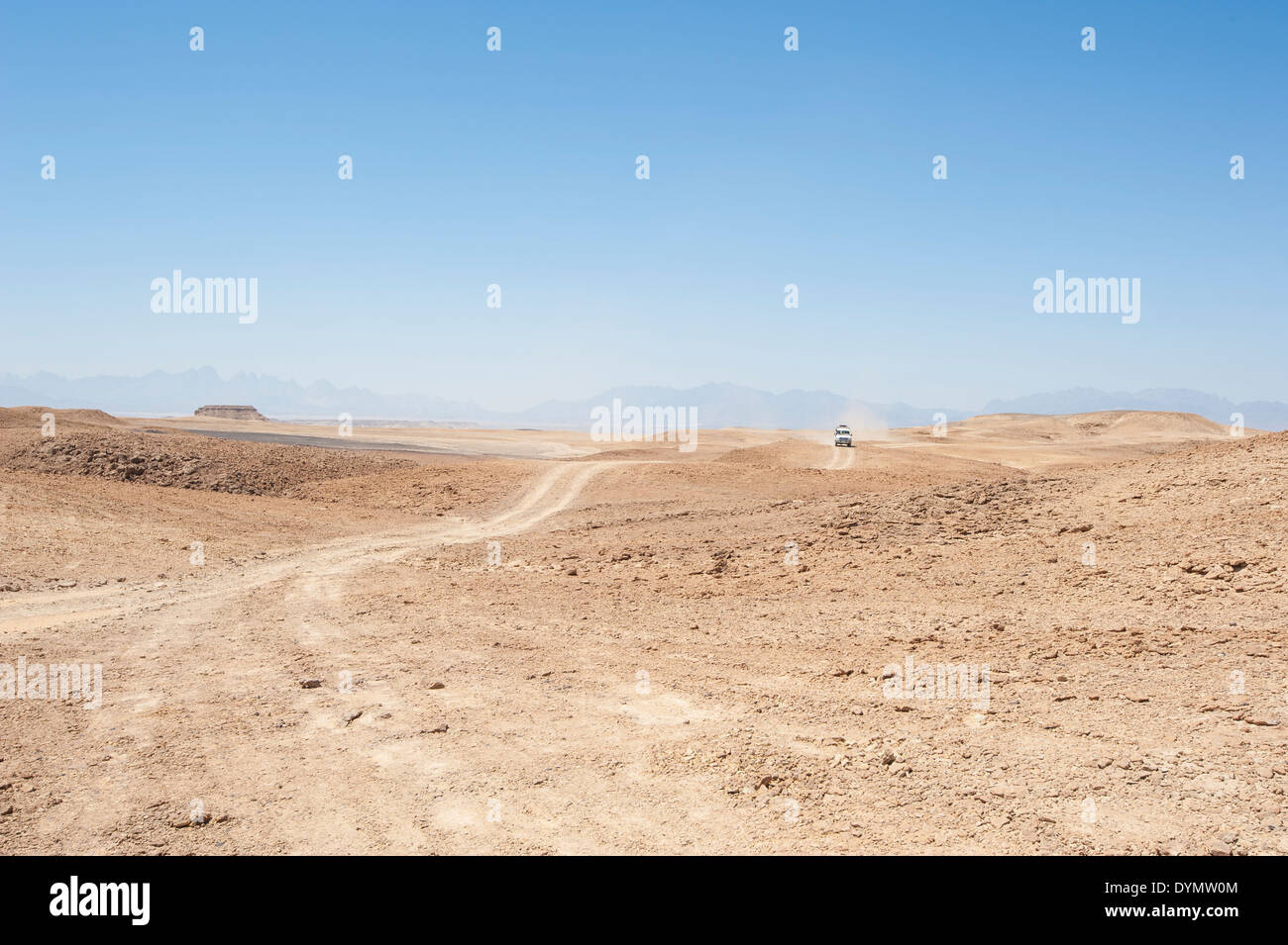 Desert safari in an off road vehicle across an empty arid desert landscape Stock Photo