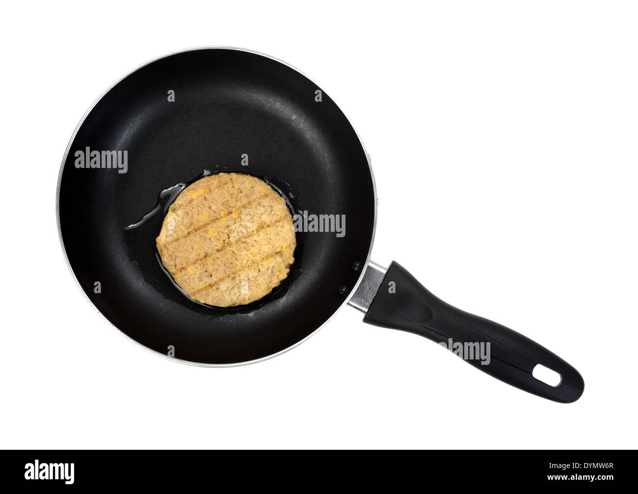 Top view of a vegetable burger patty cooking in a small frying pan
