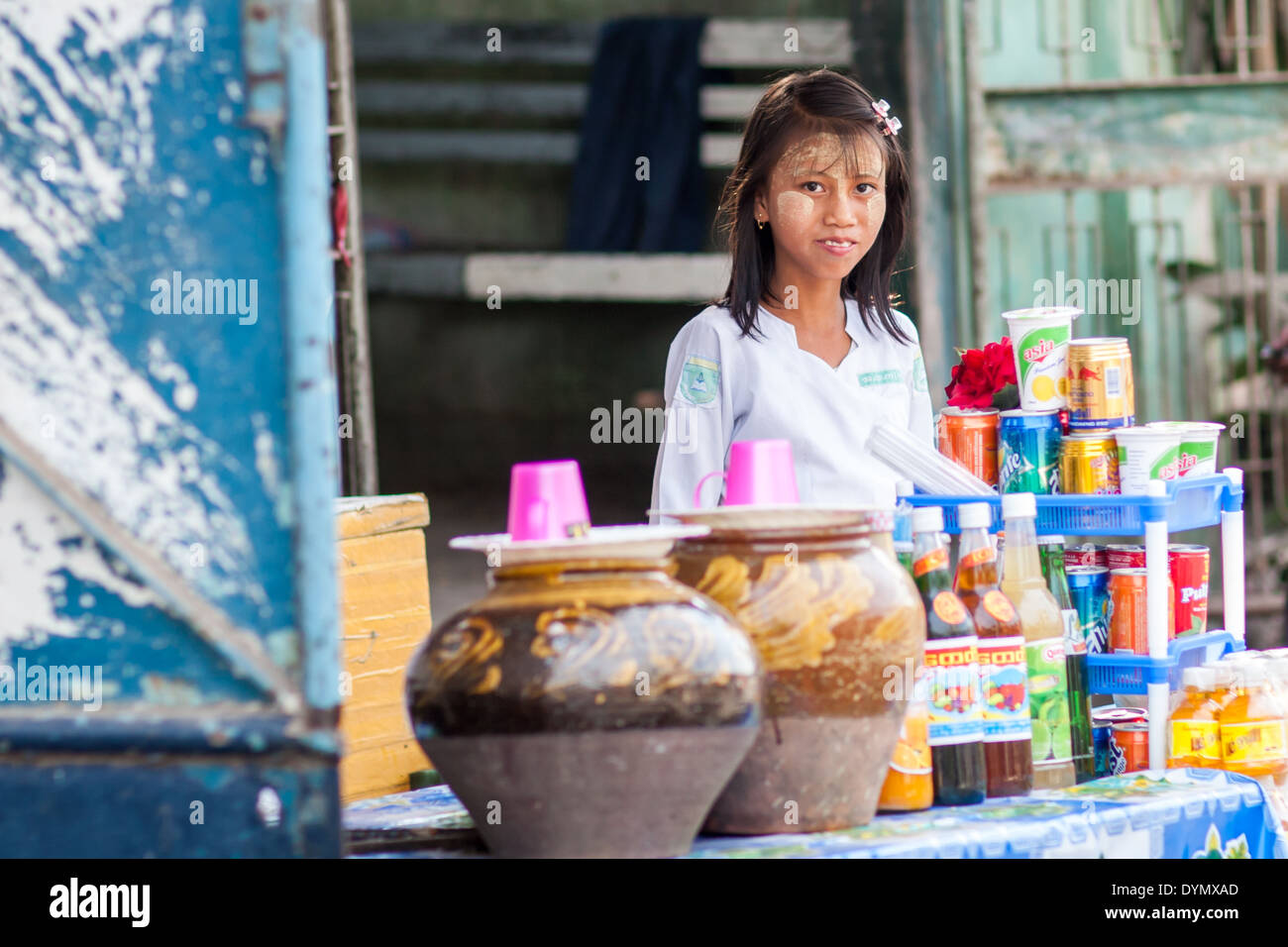 Girl on a stall selling food and drink on the street of Mandalay, Myanmar Stock Photo