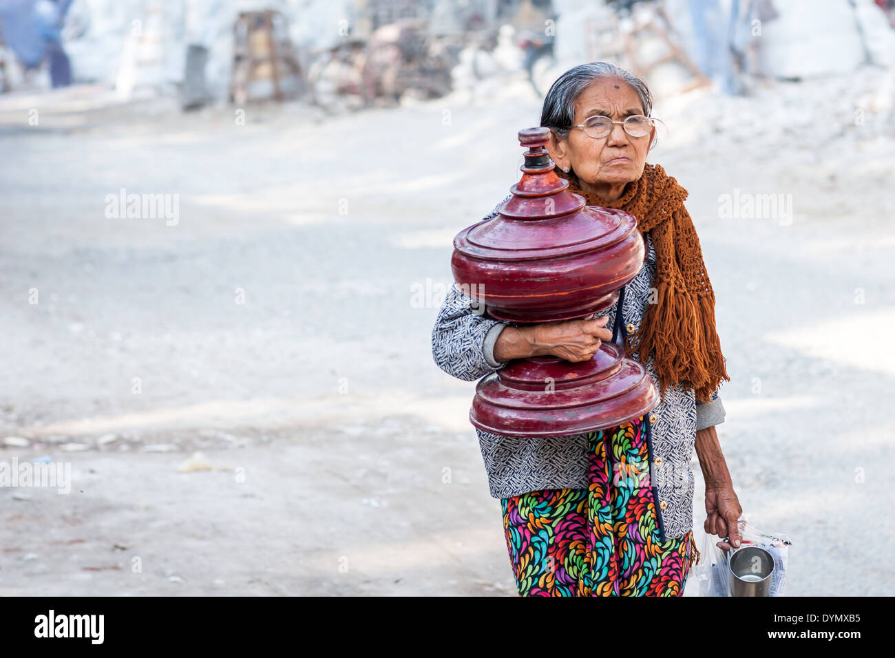 Old woman carrying an earn and shopping on the street of Mandalay, Myanmar Stock Photo