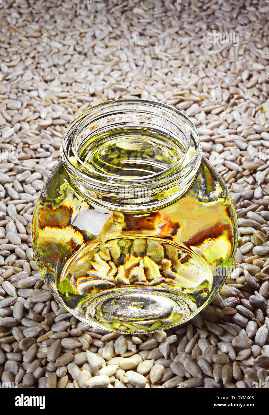 Oil from sunflower seeds in a glass jar, in the background seed Stock Photo