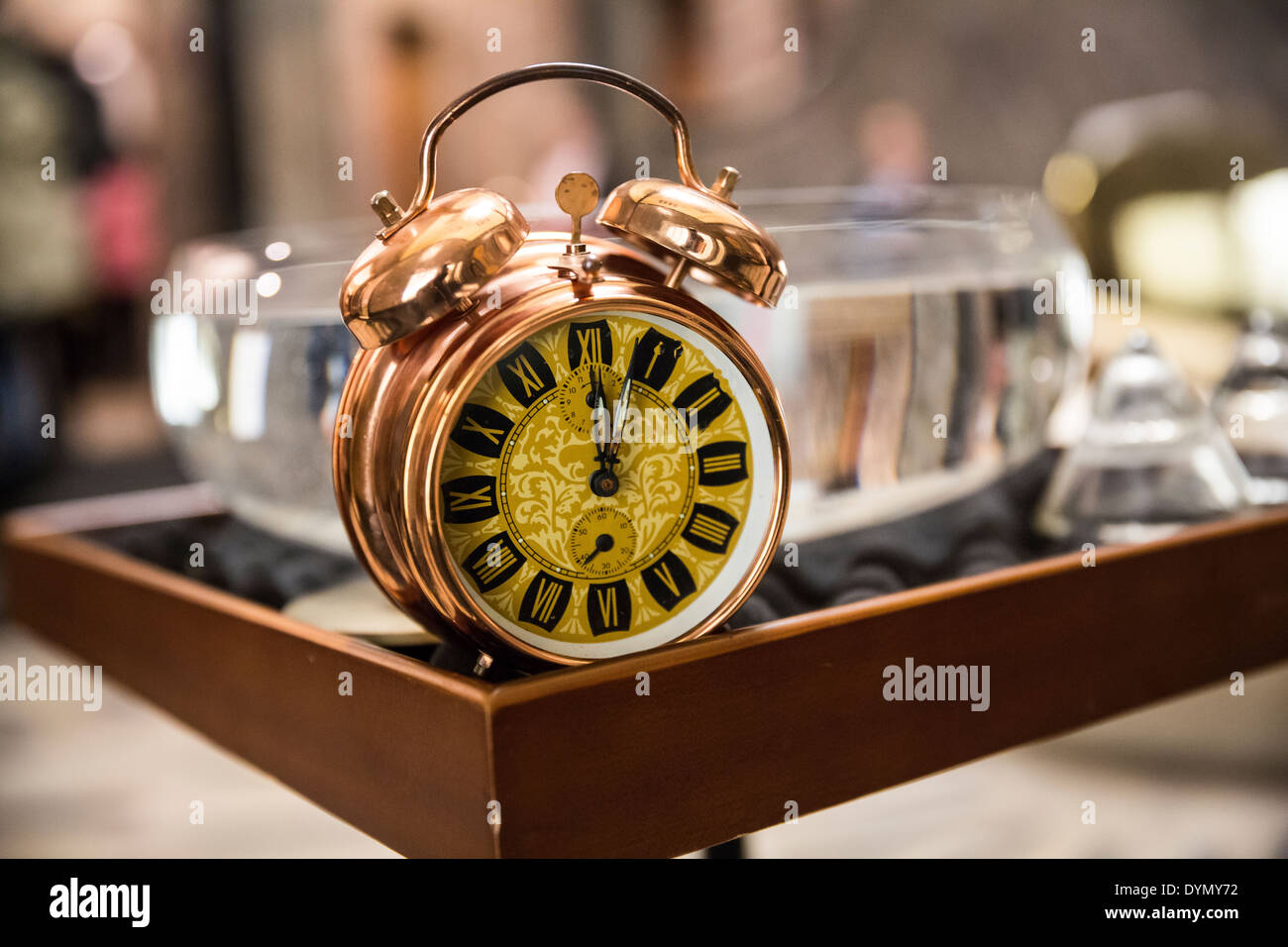Vintage alarm clock on a table. Shallow depth of field Stock Photo