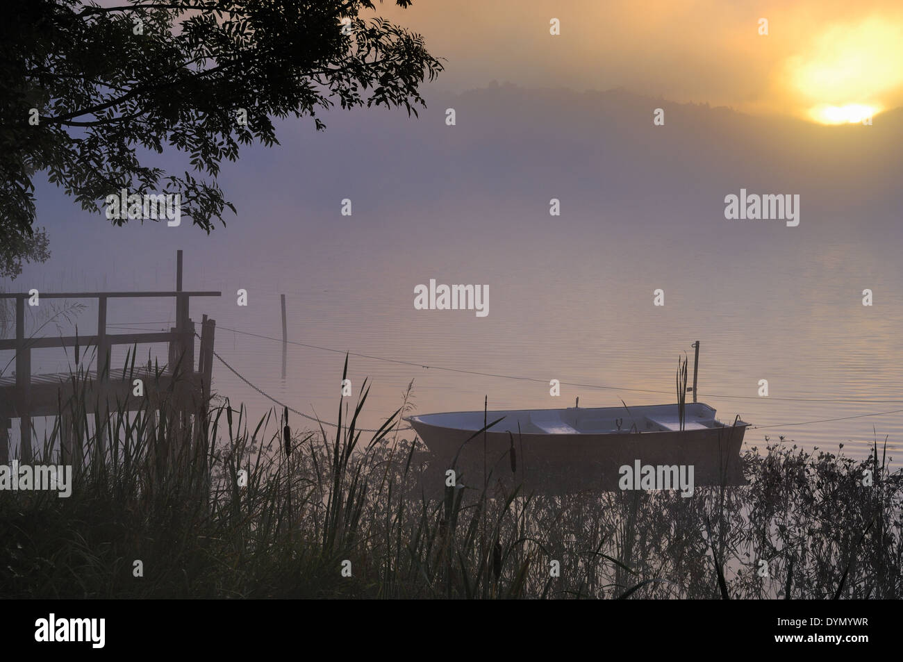 Wooden boat by pier near lake Stock Photo - Alamy