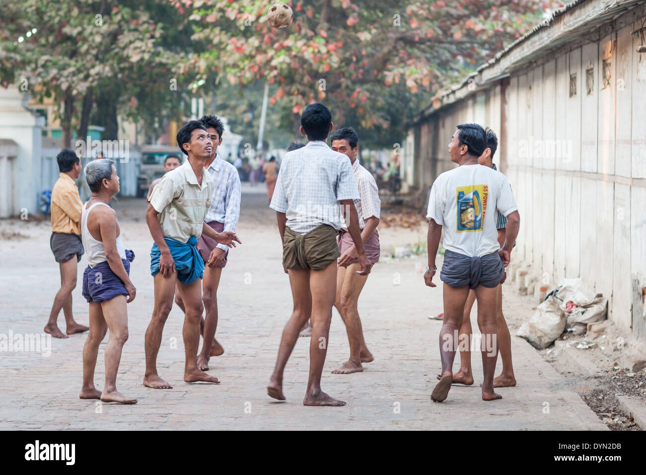 Men playing football Mandalay Myanmar Burma Stock Photo