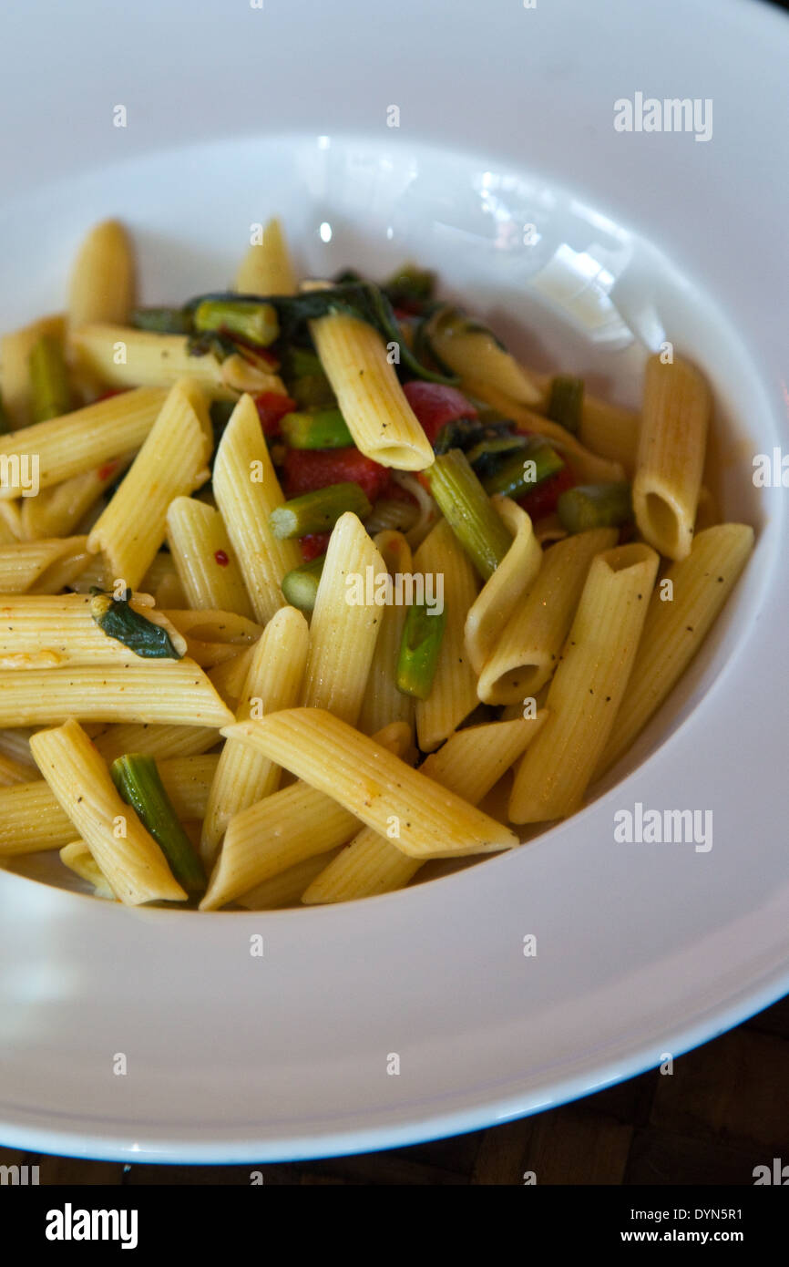 Penne pasta with vegetables in a white bowl Stock Photo