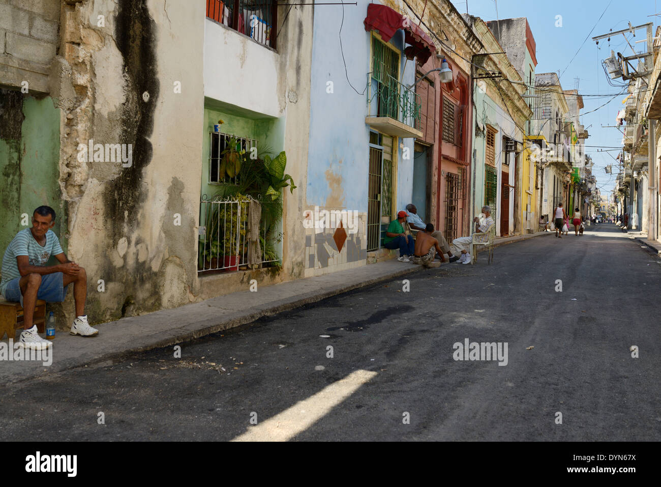 Local cubans lounging and walking in a street of Old Havana Cuba Stock Photo