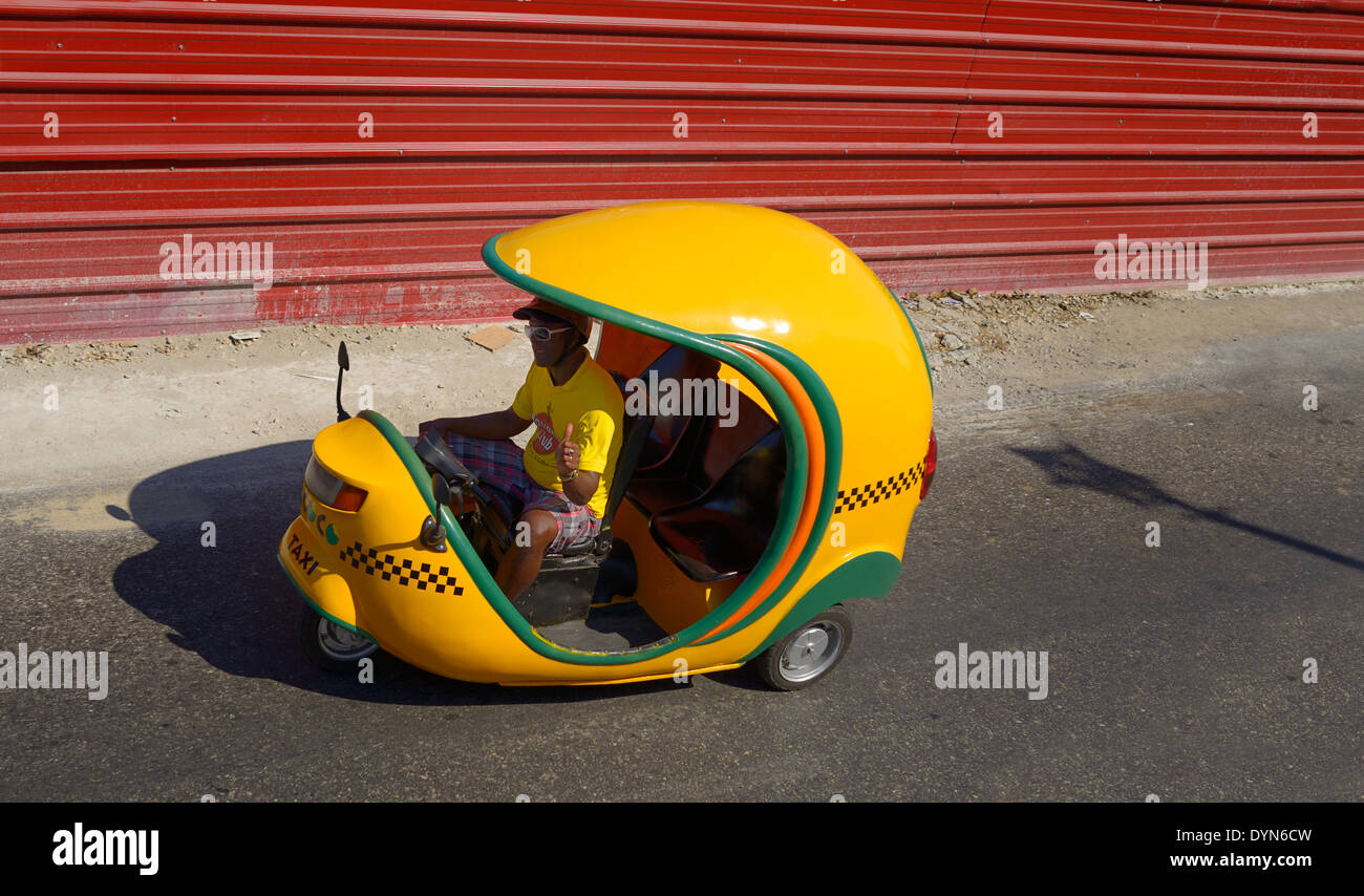 Lemon yellow Coco motor bike auto rickshaw tuk tuk taxi in Old Havana Cuba Stock Photo