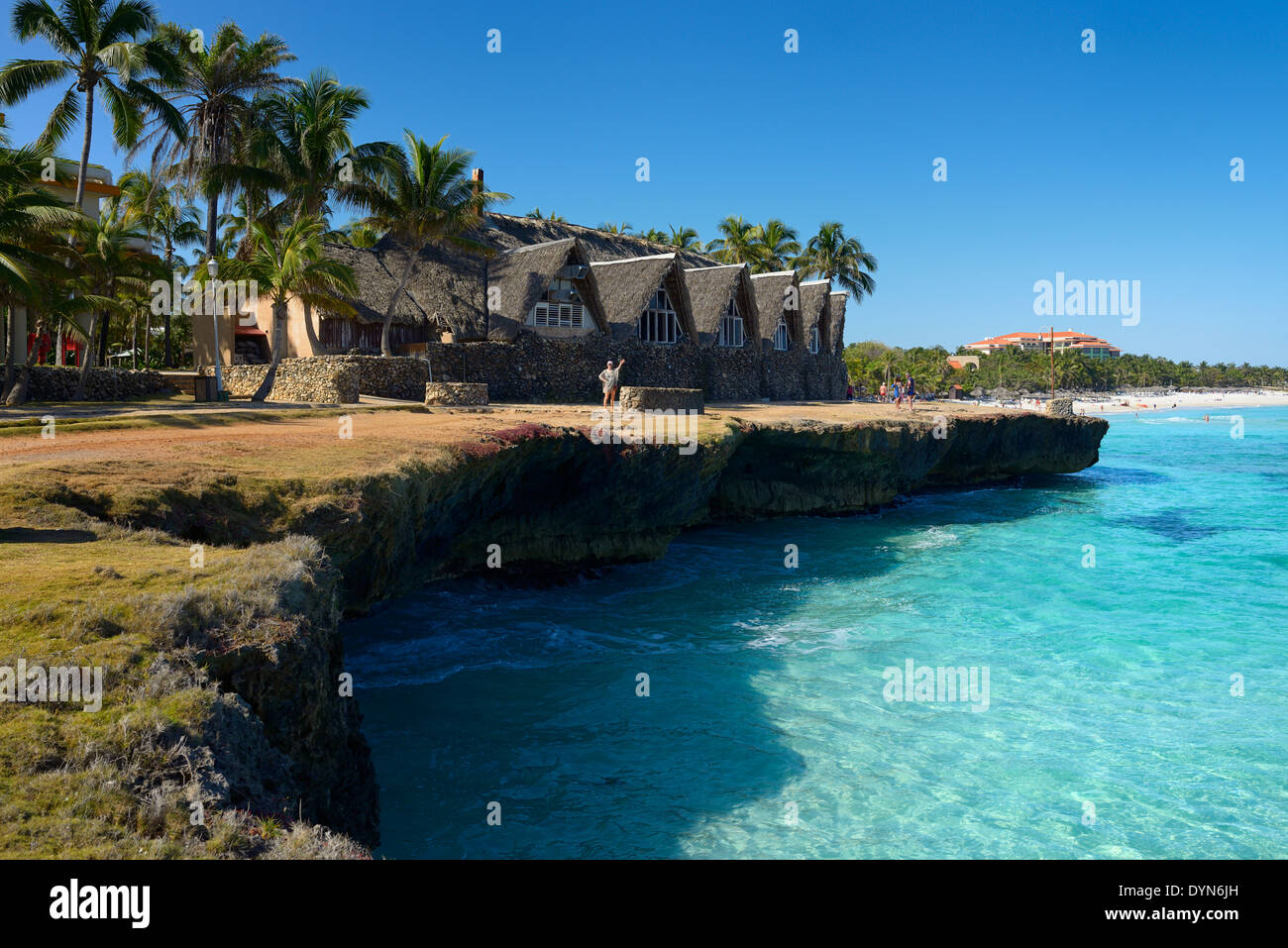 Lava rock shore and white sand beach and turquoise water at Varadero Cuba resort hotel Bay of Cardenas Atlantic ocean Stock Photo