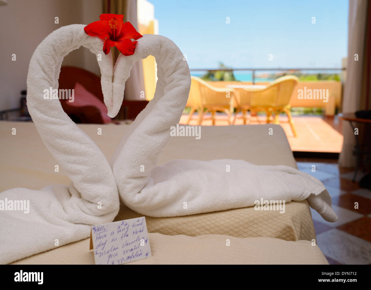 Varadero hotel room made up by maid with two towel swans and note Cuba Stock Photo