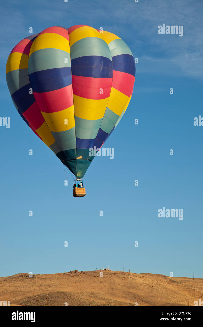 Hot air balloon rising up to the sky, to race over the desert Stock