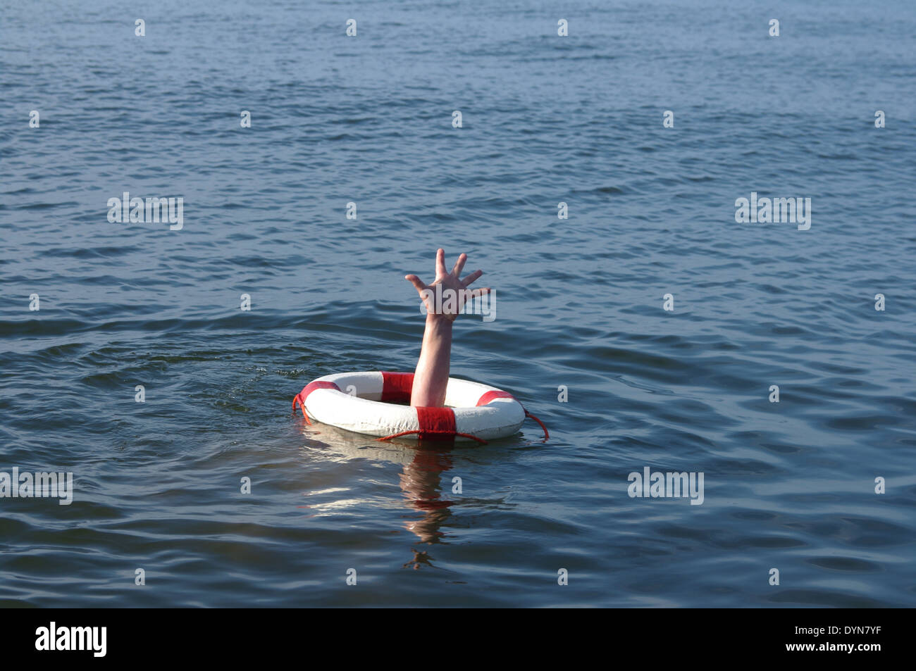 hand calling protruding from rescue wheel help Stock Photo