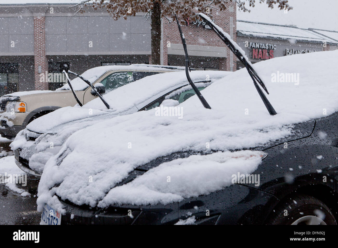 Raised car windshield wipers during snow storm - USA Stock Photo