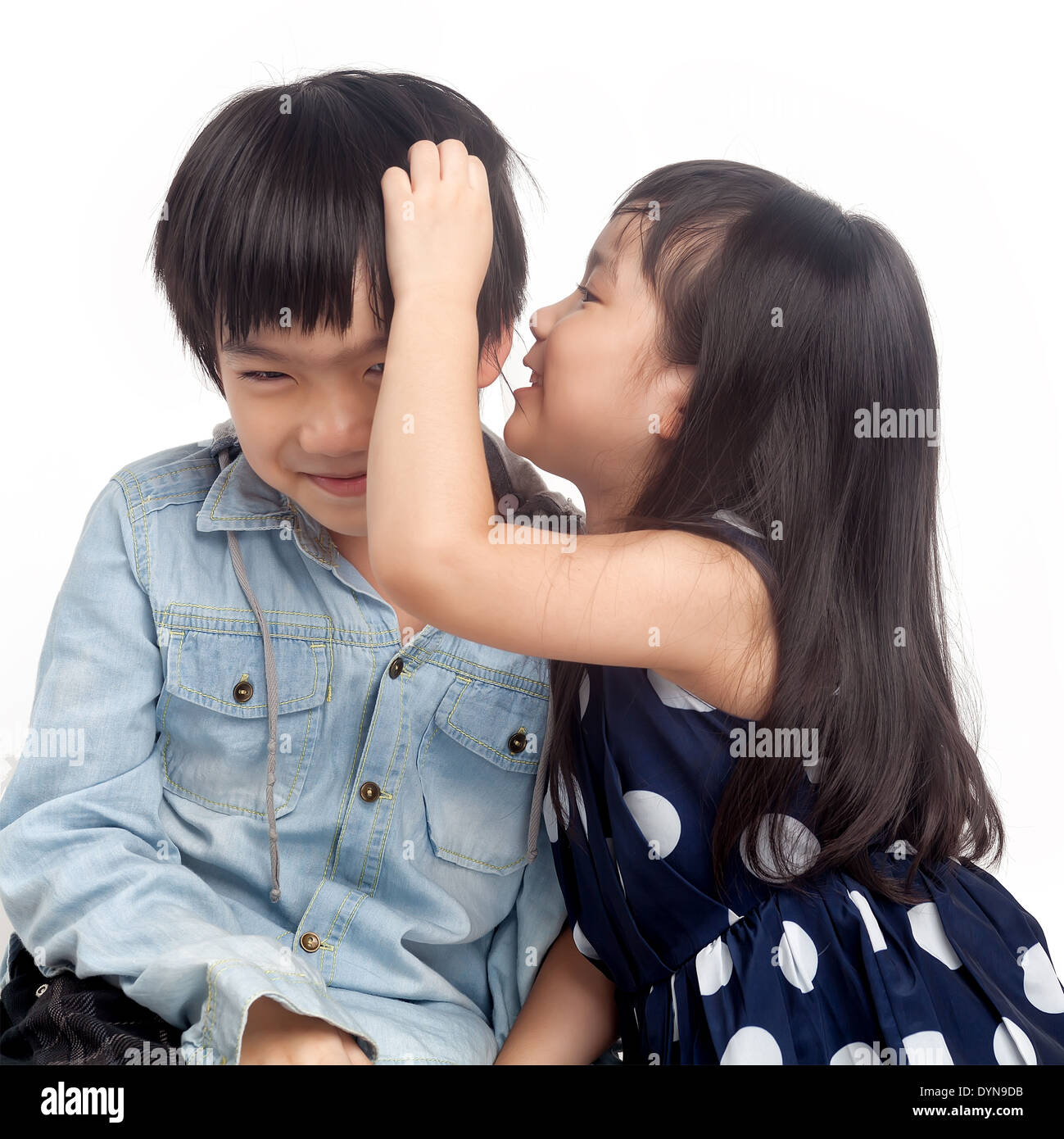 Kids whispering on white background Stock Photo