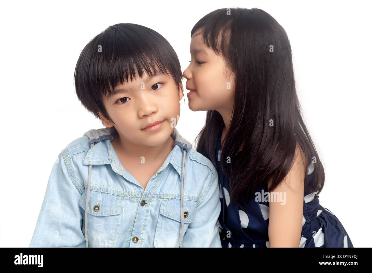 Kids sharing secret on white background Stock Photo