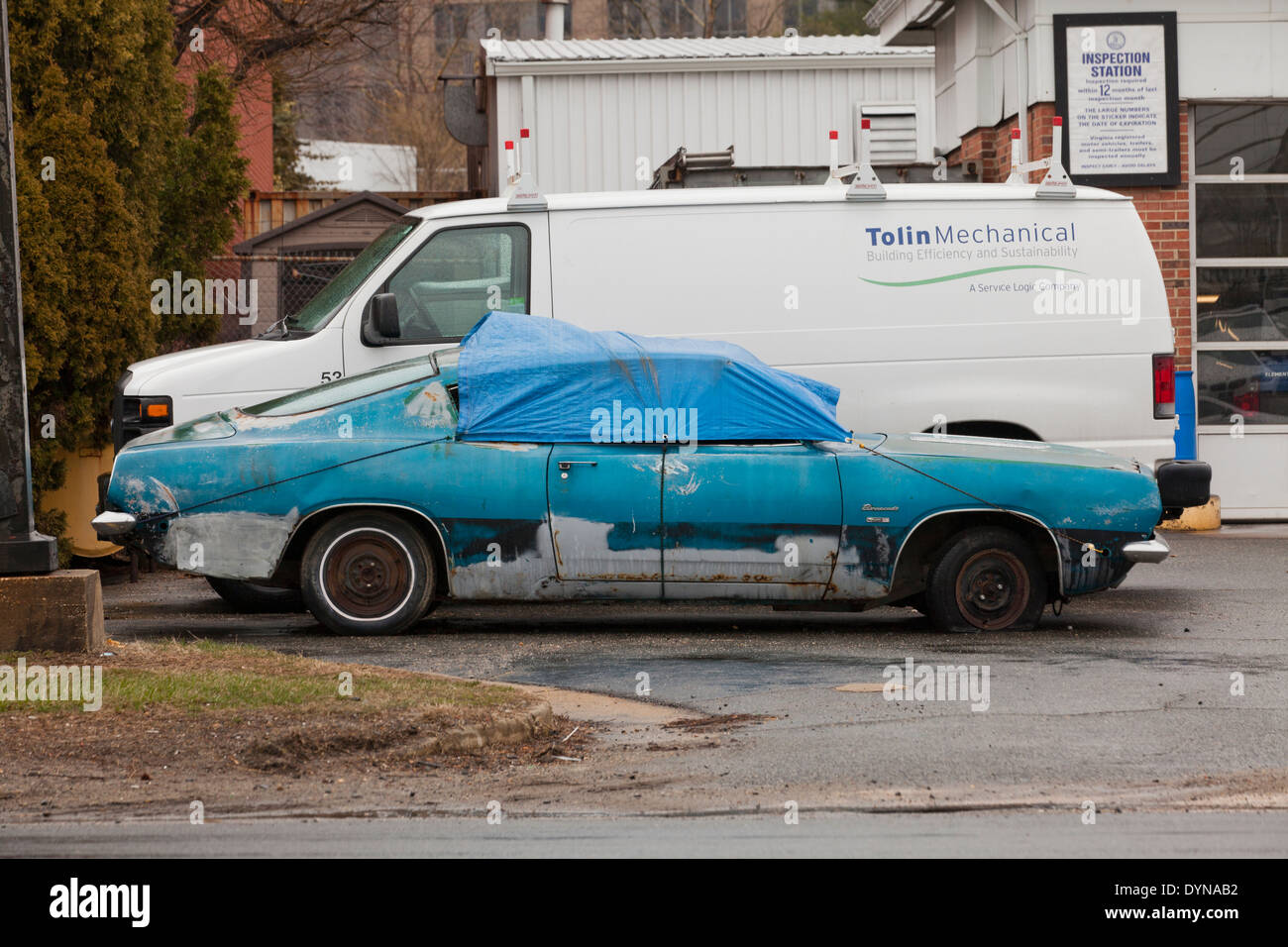 Run-down 1968 Plymouth Barracuda Coupe car covered with tarp - USA Stock Photo
