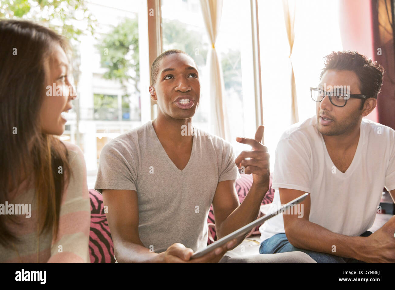Friends with digital tablet in cafe Stock Photo