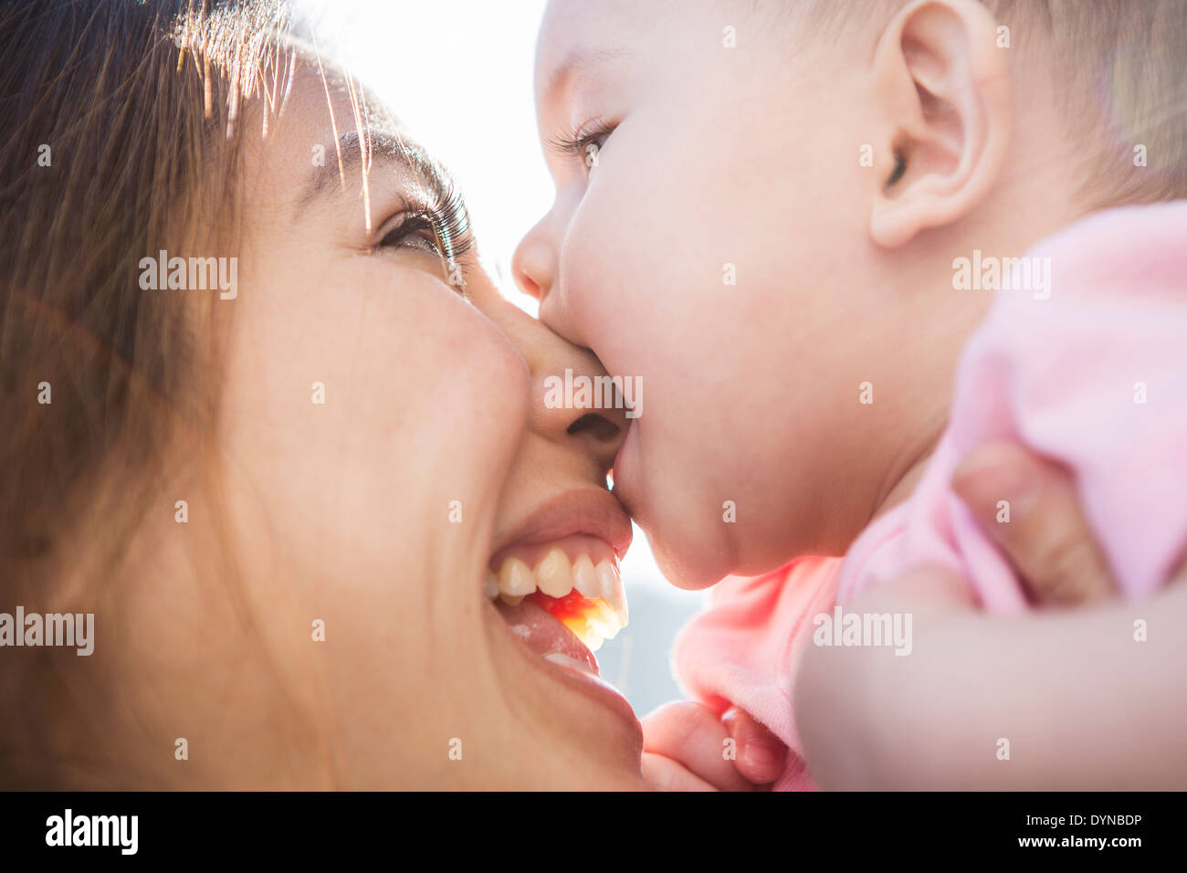 Mother playing with baby girl outdoors Stock Photo