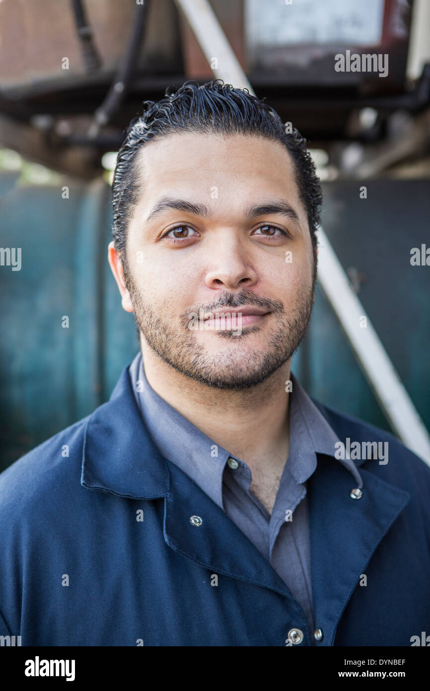 Hispanic blue collar worker smiling outdoors Stock Photo