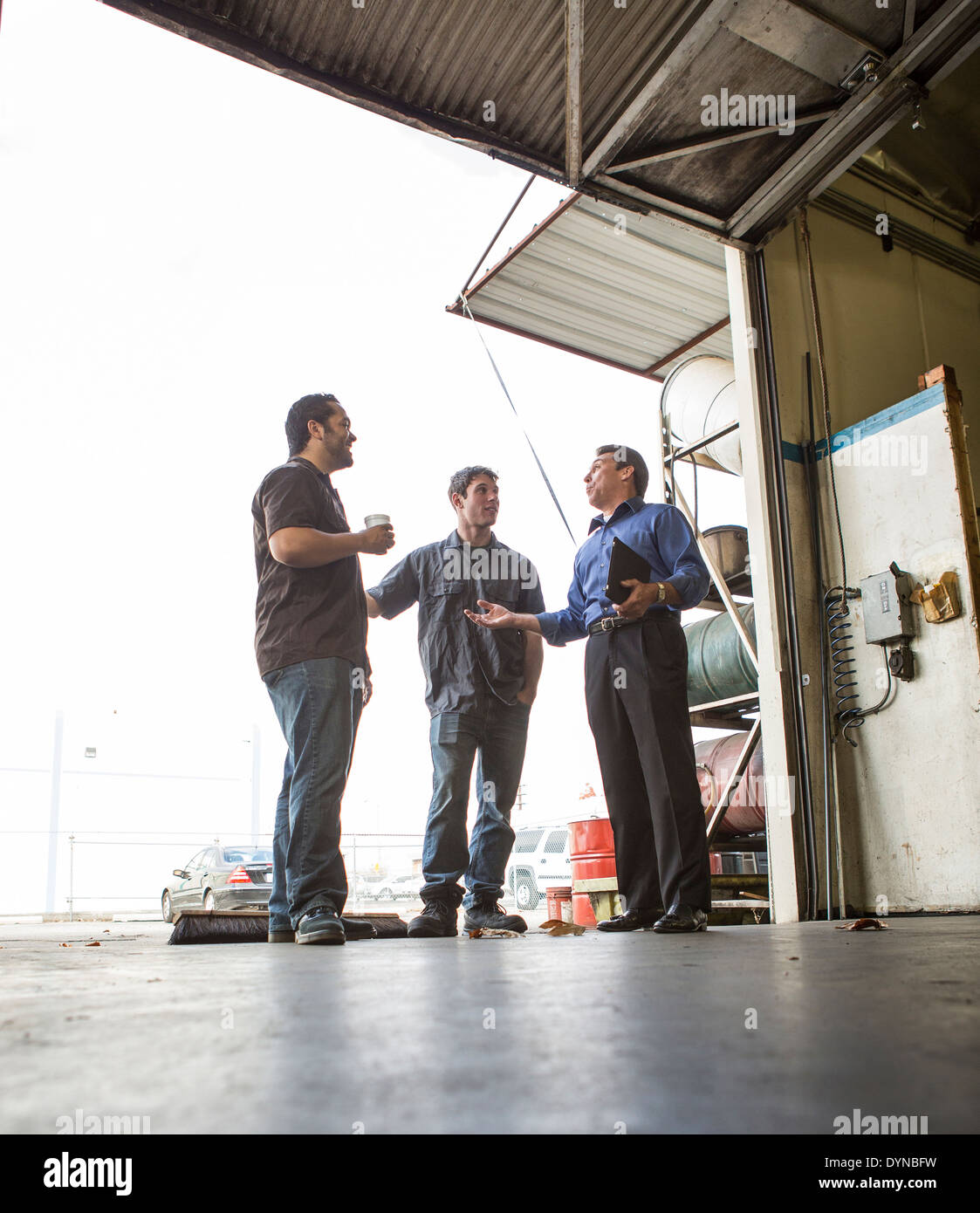 Manager and workers talking at warehouse loading dock Stock Photo Alamy