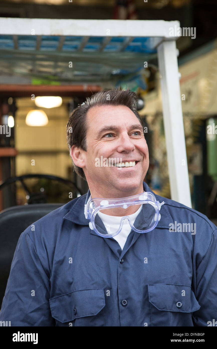 Caucasian worker smiling in warehouse Stock Photo