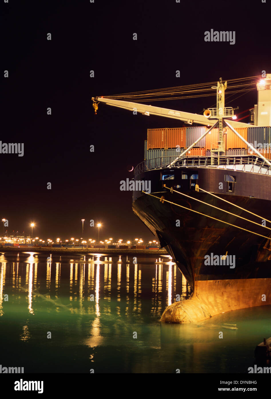 Illuminated crane and container ship at night, Port of Los Angeles, California, United States Stock Photo