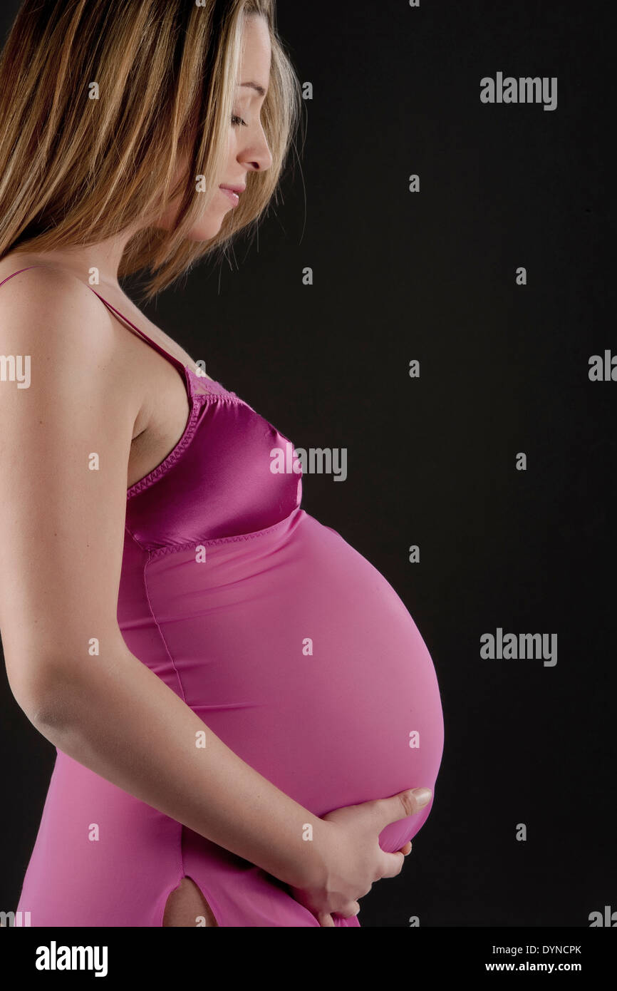 Pregnant Caucasian woman holding her belly Stock Photo Alamy