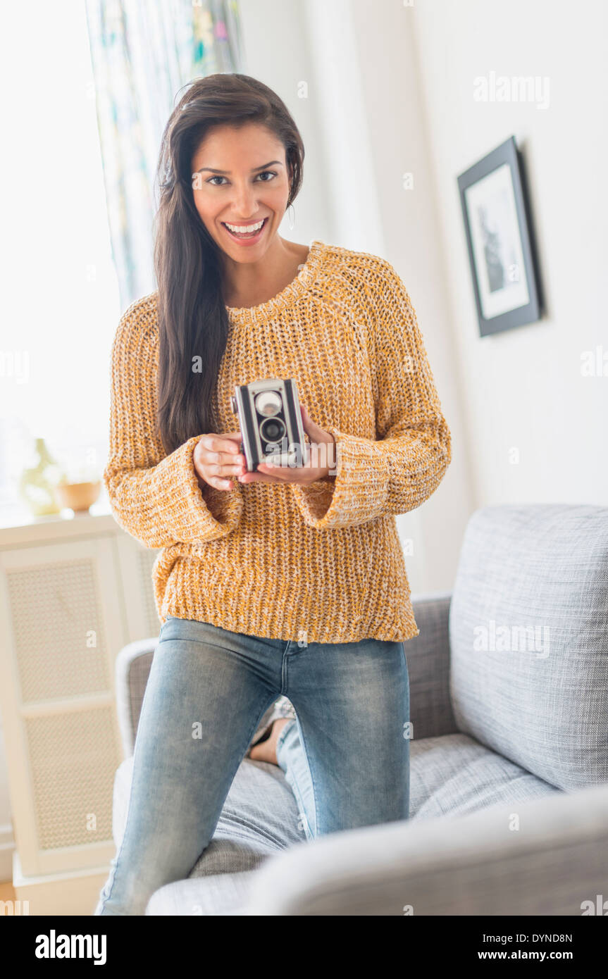 Hispanic woman using vintage camera Stock Photo