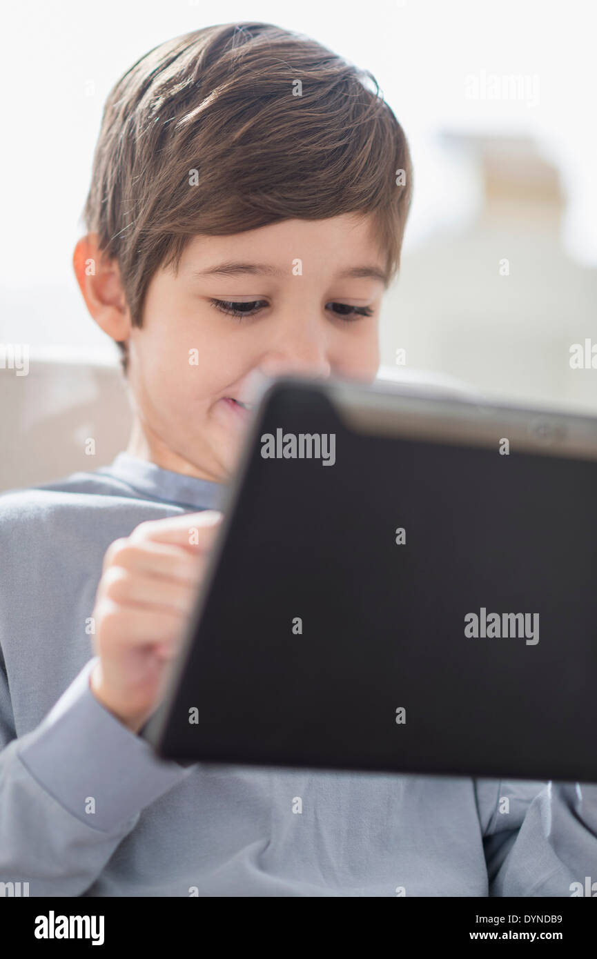 Hispanic boy using digital tablet Stock Photo