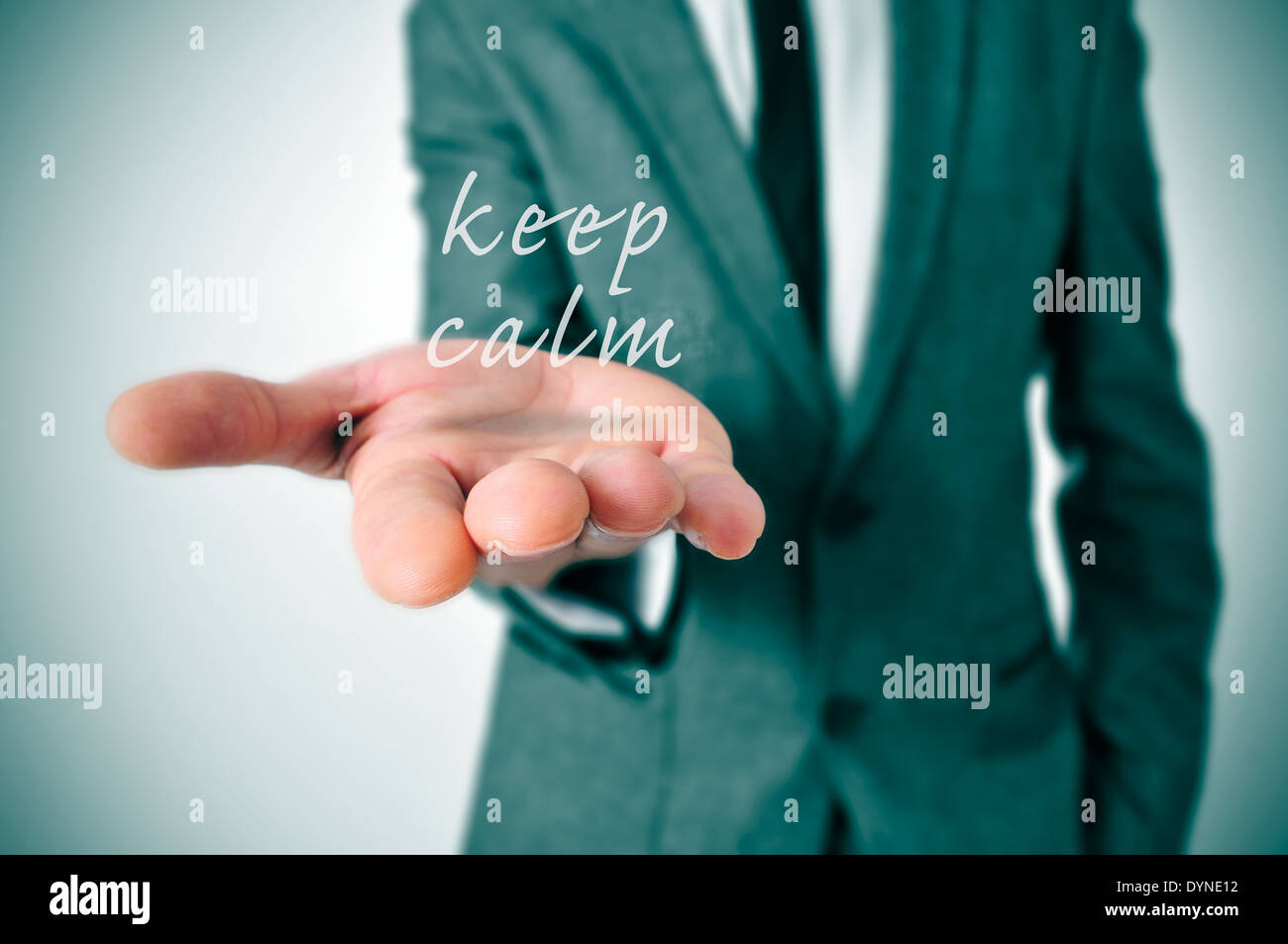 man wearing a suit with the text keep calm in his hand Stock Photo