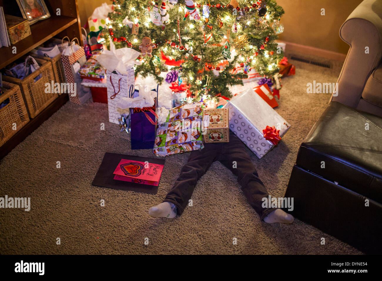Caucasian boy buried in Christmas gifts Stock Photo