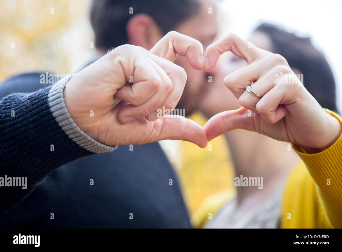 Caucasian couple making heart shape with fingers Stock Photo - Alamy