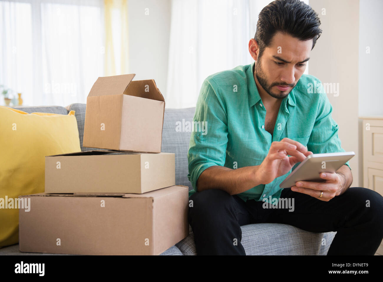 Mixed race man using digital tablet and moving Stock Photo