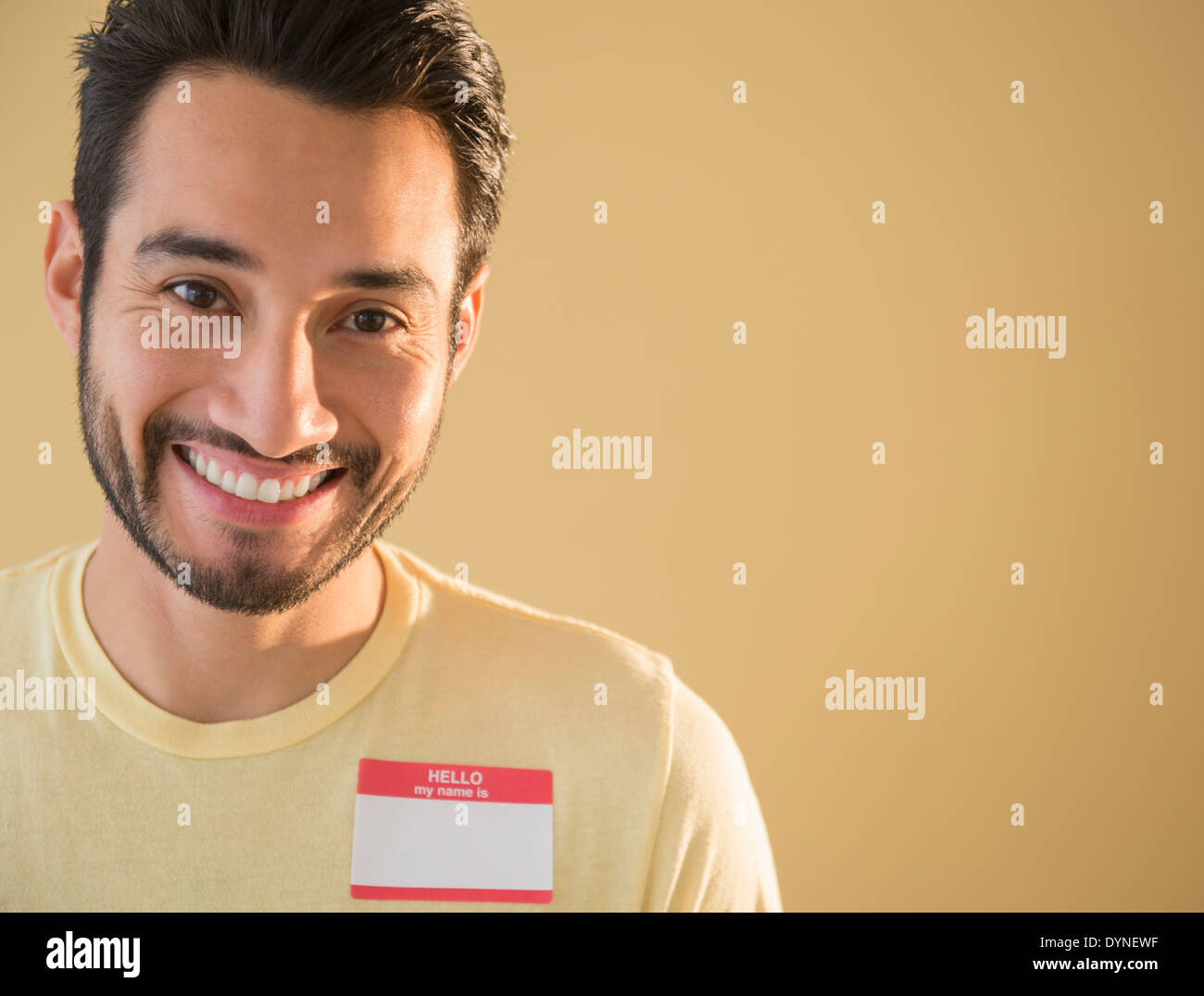 Mixed race man wearing name tag Stock Photo Alamy