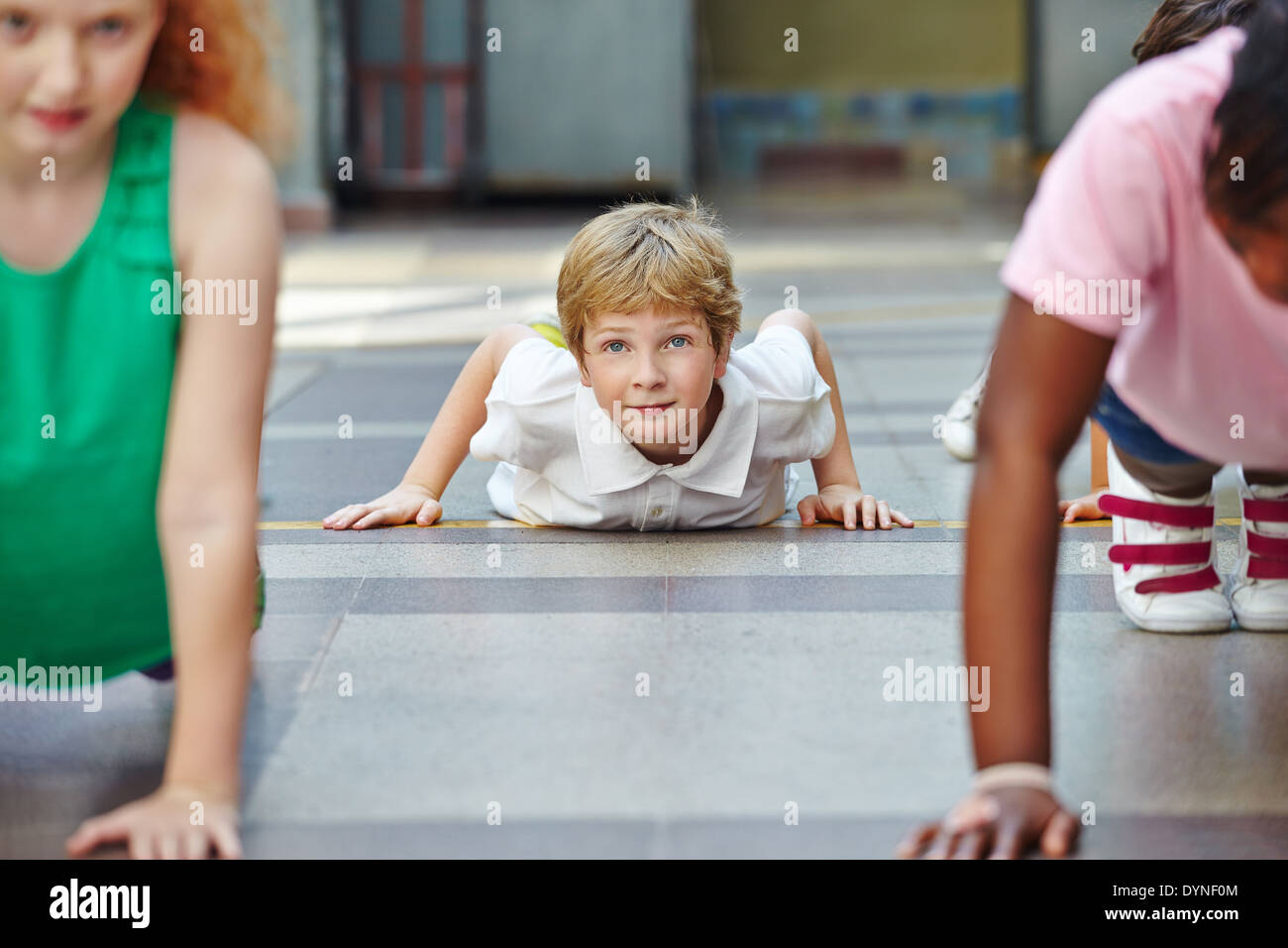 Children doing push ups in PE in elementary school Stock Photo