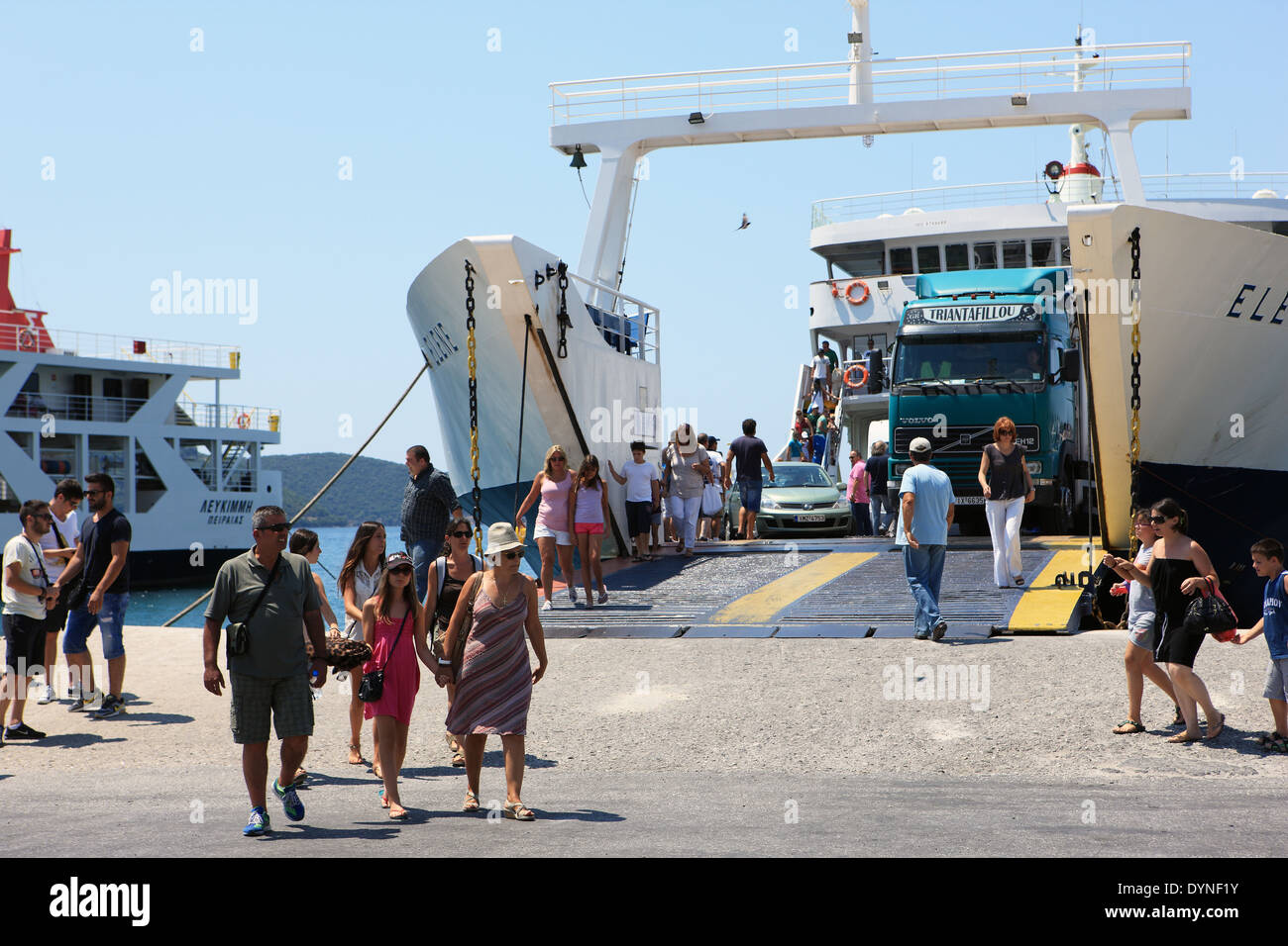 Vehicles and people going on and off ferries at Igoumenitsa a busy ferry port on the mainland of North West Greece Stock Photo