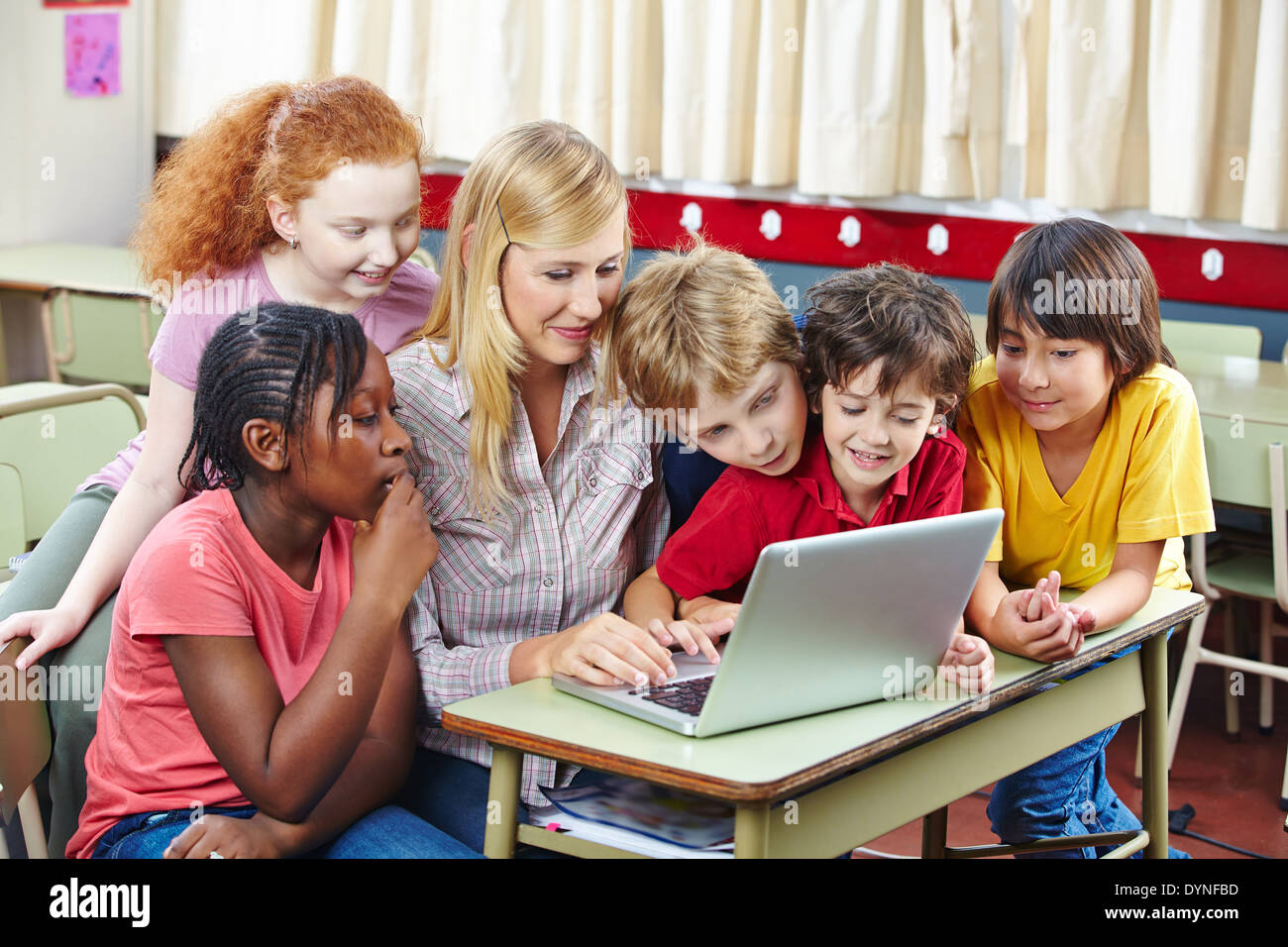 Students learning with laptop computer in elementary school class Stock ...
