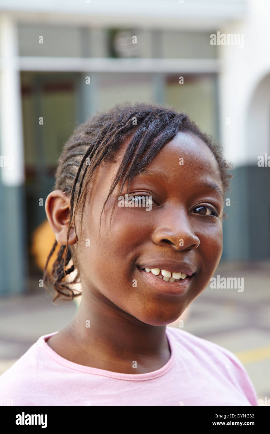 Portrait of happy african girl on schoolyard in elementary school Stock Photo