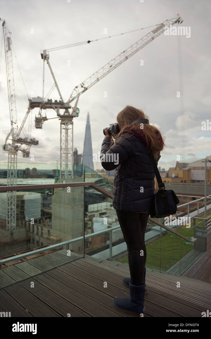 Young girl photographing the views at the Skylounge, Double Tree Hilton, London, UK. Stock Photo