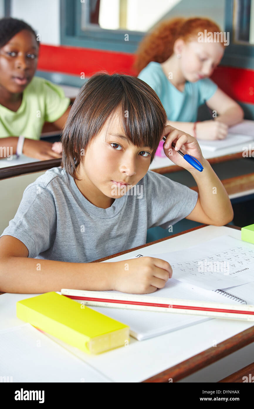 Pensive Japanese child in class in elementary school Stock Photo