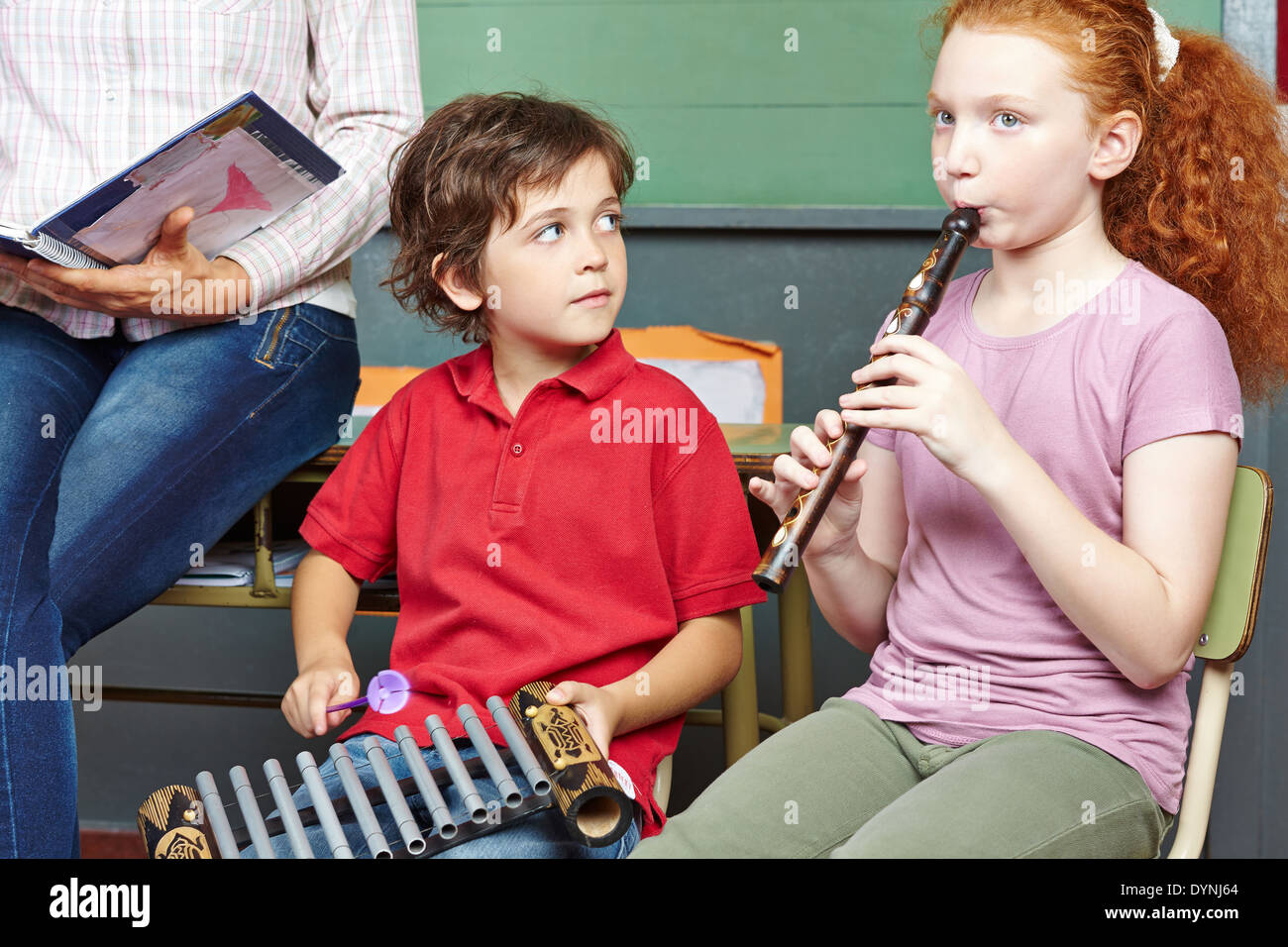 Children having music lessons in elementary school class Stock Photo