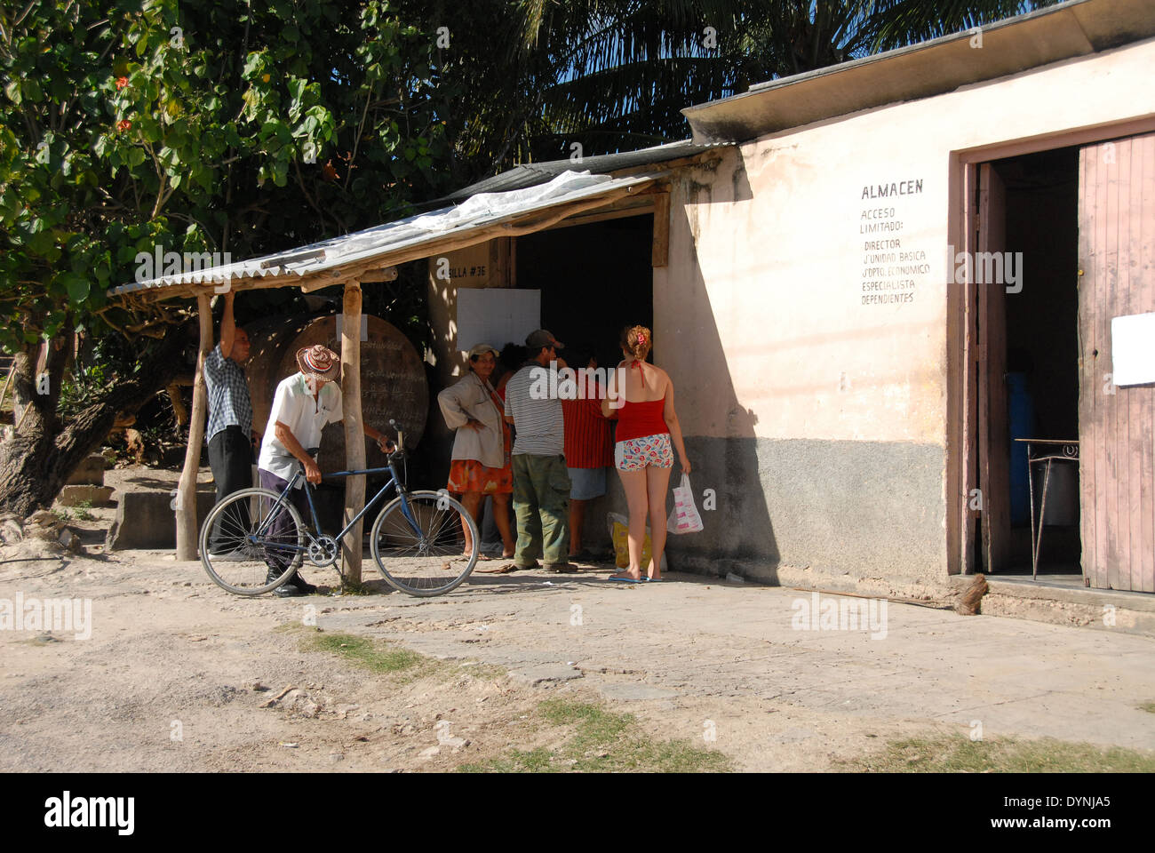 A Cuban ration shop in a village near to Guardalavaca, with Cuban people waiting to be served Stock Photo