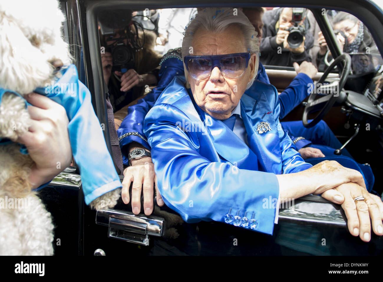 Paris, France. 19th Apr, 2014. French cabaret director, Michel Georges Alfred Catty a.k.a Michou arrival in the Michou Day flashMob in Paris, with a blue dresscode, on April 19, 2014. Around 200 people gathered, dressed in blue to throw up confetti, in Jehan Rictus Square in Montmartre, Paris. (Photo by Michael Bunel/NurPhoto) © Michael Bunel/NurPhoto/ZUMAPRESS.com/Alamy Live News Stock Photo