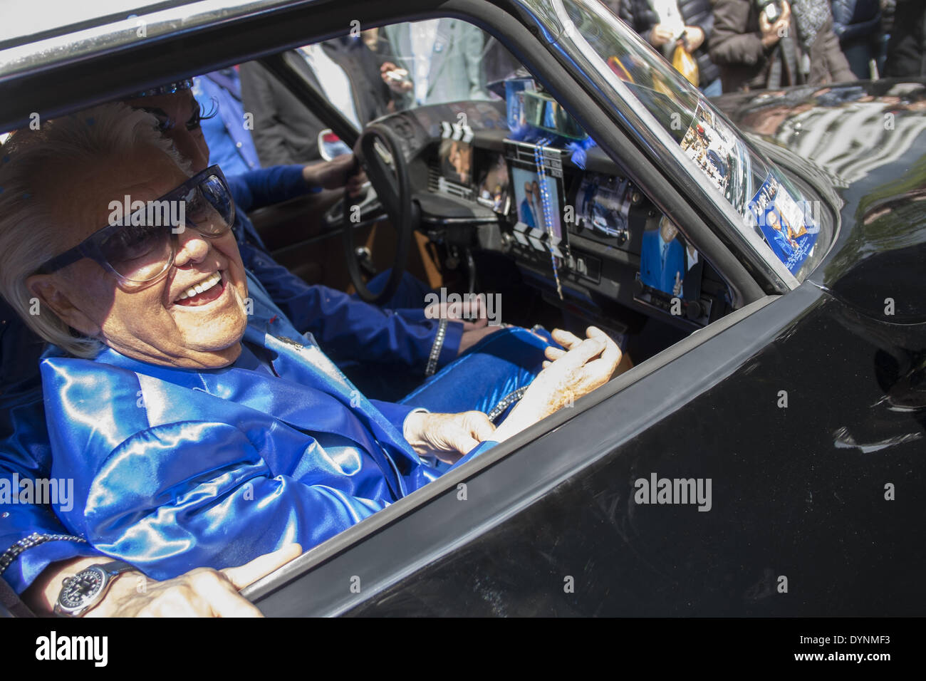 Paris, France. 19th Apr, 2014. French cabaret director, Michel Georges Alfred Catty a.k.a Michou arrival in the Michou Day flashMob in Paris, with a blue dresscode, on April 19, 2014. Around 200 people gathered, dressed in blue to throw up confetti, in Jehan Rictus Square in Montmartre, Paris. (Photo by Michael Bunel/NurPhoto) © Michael Bunel/NurPhoto/ZUMAPRESS.com/Alamy Live News Stock Photo