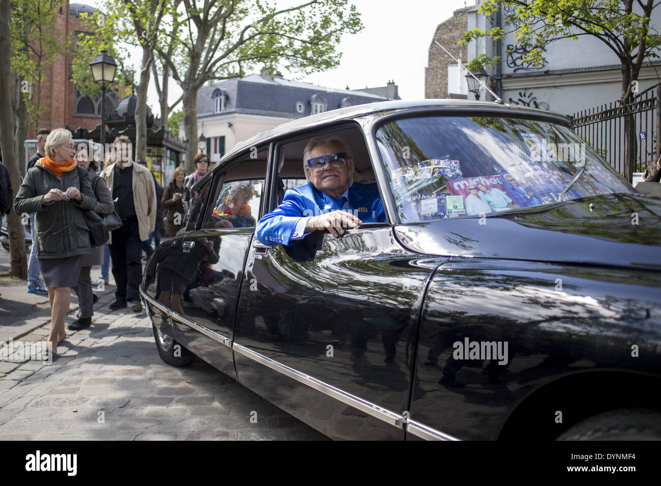 Paris, France. 19th Apr, 2014. French cabaret director, Michel Georges Alfred Catty a.k.a Michou arrival in the Michou Day flashMob in Paris, with a blue dresscode, on April 19, 2014. Around 200 people gathered, dressed in blue to throw up confetti, in Jehan Rictus Square in Montmartre, Paris. (Photo by Michael Bunel/NurPhoto) © Michael Bunel/NurPhoto/ZUMAPRESS.com/Alamy Live News Stock Photo