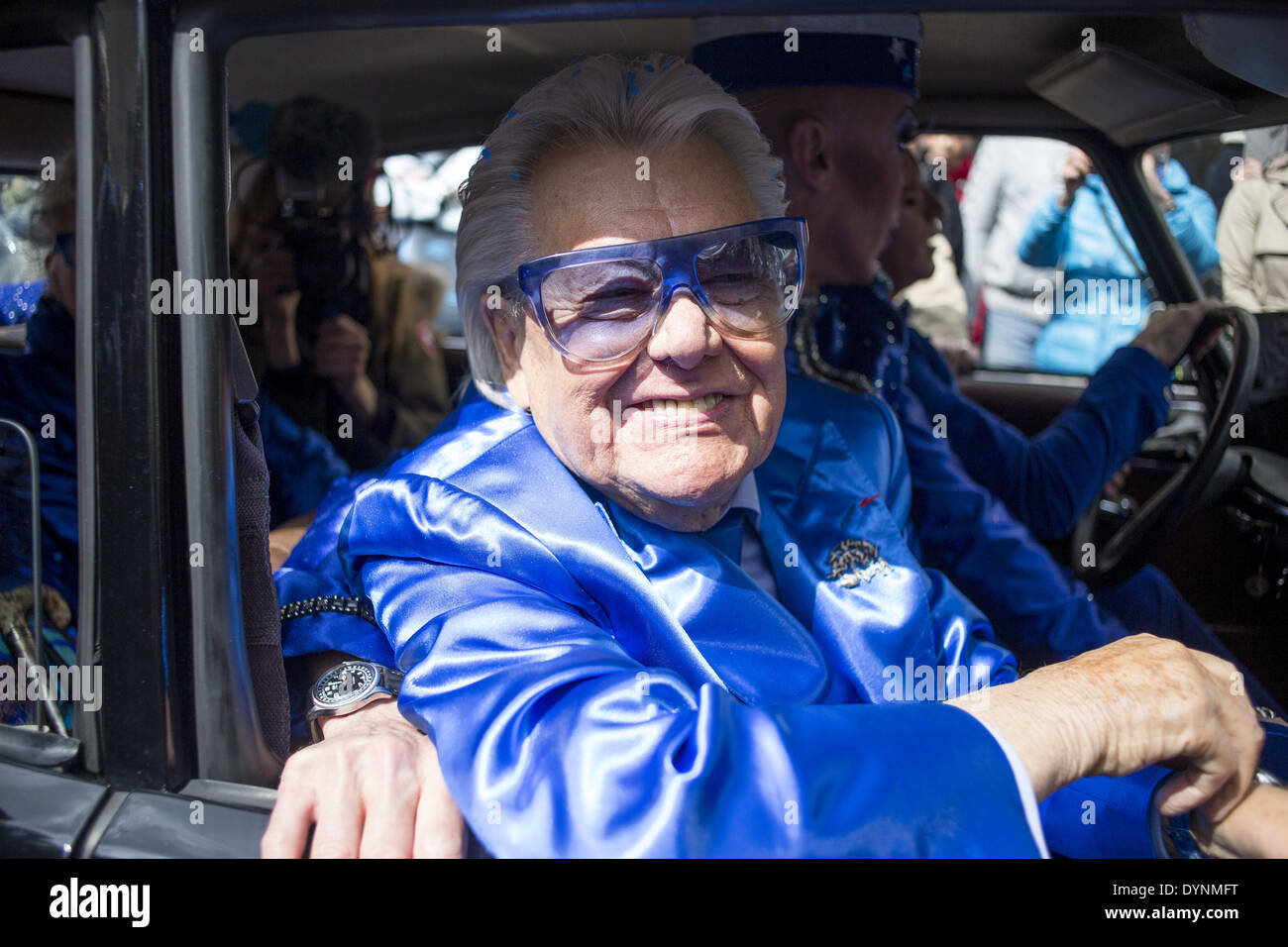 Paris, France. 19th Apr, 2014. French cabaret director, Michel Georges Alfred Catty a.k.a Michou arrival in the Michou Day flashMob in Paris, with a blue dresscode, on April 19, 2014. Around 200 people gathered, dressed in blue to throw up confetti, in Jehan Rictus Square in Montmartre, Paris. (Photo by Michael Bunel/NurPhoto) © Michael Bunel/NurPhoto/ZUMAPRESS.com/Alamy Live News Stock Photo