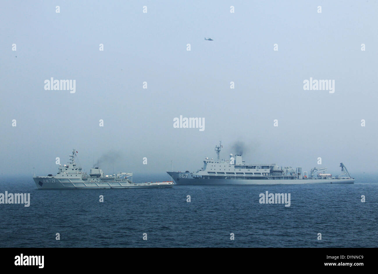 Qingdao. 23rd Apr, 2014. Photo taken on April 23, 2014 shows the scene of the multi-country maritime exercises off the coast of Qingdao, east China's Shandong Province. Nineteen ships, seven helicopters and marine corps from eight countries including China, Bangladesh, Pakistan, Singapore, Indonesia, India, Malaysia and Brunei were organized into three task forces to conduct the exercises dubbed 'Maritime Cooperation - 2014'. Credit:  Zha Chunming/Xinhua/Alamy Live News Stock Photo