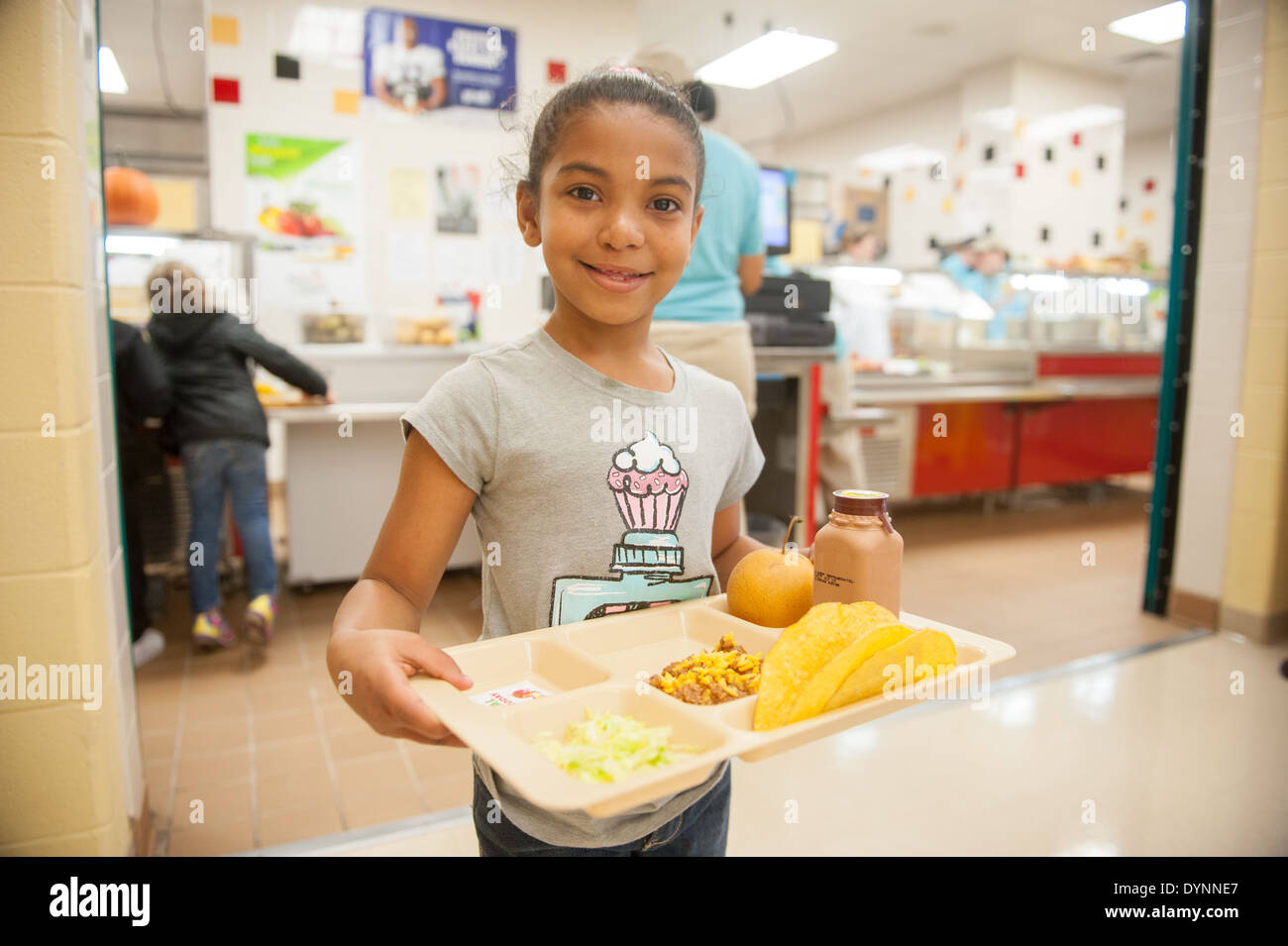 African American elementary school girl smiling after receiving her healthy lunch Hagerstown, Maryland Stock Photo