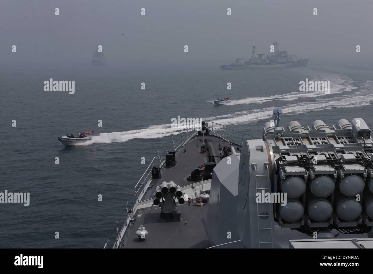 Qingdao. 23rd Apr, 2014. Photo taken on April 23, 2014 shows the scene of the multi-country maritime exercises off the coast of Qingdao, east China's Shandong Province. Nineteen ships, seven helicopters and marine corps from eight countries including China, Bangladesh, Pakistan, Singapore, Indonesia, India, Malaysia and Brunei were organized into three task forces to conduct the exercises dubbed 'Maritime Cooperation - 2014'. Credit:  Wang Jianmin/Xinhua/Alamy Live News Stock Photo